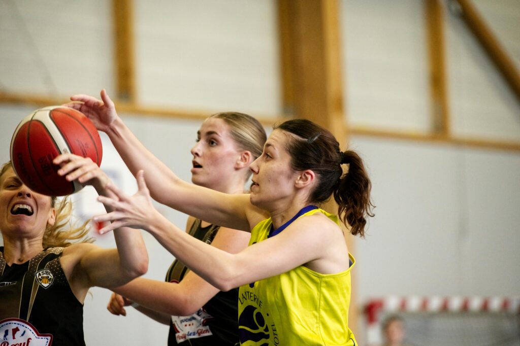pexels photo 30049751 30049751 Close-up of women basketball players in a competitive game, reaching for a ball indoors.